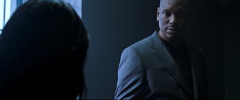 Movie still from “Morbius” (2022), directed by Daniel Espinosa – A man wearing a suit and tie in front of a mirror; Medium shot, Over the shoulder angle