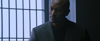 Movie still from “Morbius” (2022), directed by Daniel Espinosa – A man wearing a suit and a black t - shirt; Close Up shot, Over the shoulder angle