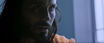 Movie still from “Morbius” (2022), directed by Daniel Espinosa – A person with long hair and a beard; Close Up shot, Over the shoulder angle