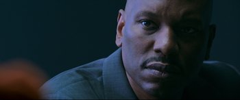 Movie still from “Morbius” (2022), directed by Daniel Espinosa – A man's face in a dark room; Close Up shot, Low angle