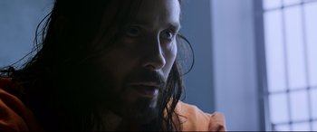 Movie still from “Morbius” (2022), directed by Daniel Espinosa – A person with long black hair; Close Up shot, Over the shoulder angle