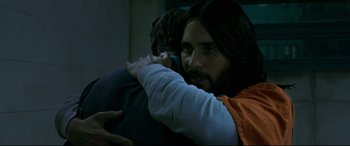 Movie still from “Morbius” (2022), directed by Daniel Espinosa – Jared leto hugging another person in a room; Close Up shot, Over the shoulder angle