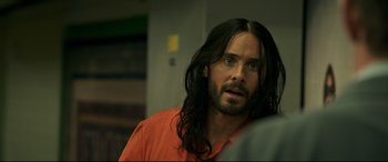 Movie still from “Morbius” (2022), directed by Daniel Espinosa – A man with long black hair and a red shirt; Close Up shot, Over the shoulder angle