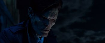 Movie still from “Morbius” (2022), directed by Daniel Espinosa – A person wearing a suit and tie; Close Up shot, Over the shoulder angle