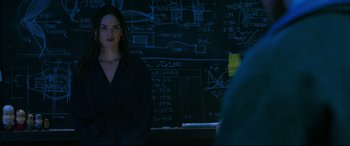 Movie still from “Morbius” (2022), directed by Daniel Espinosa – A woman standing in front of a chalkboard with a lot of writing on it; Medium shot, Over the shoulder angle