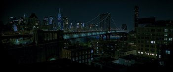 Movie still from “Morbius” (2022), directed by Daniel Espinosa – A view of a bridge lit up at night; Extreme Wide shot, High angle