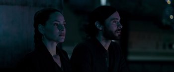 Movie still from “Morbius” (2022), directed by Daniel Espinosa – A man and a woman sitting next to each other in the dark; Close Up shot, Over the shoulder angle