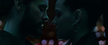 Movie still from “Morbius” (2022), directed by Daniel Espinosa – A man and a woman face to face in front of lights; Close Up shot, Over the shoulder angle