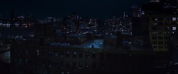 Movie still from “Morbius” (2022), directed by Daniel Espinosa – A view of a city at night from a roof top; Extreme Wide shot, High angle
