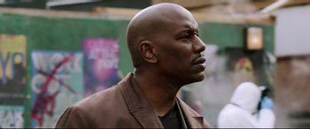 Movie still from “Morbius” (2022), directed by Daniel Espinosa – A man with a bald head wearing a brown jacket; Close Up shot, Low angle