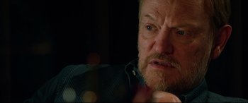 Movie still from “Morbius” (2022), directed by Daniel Espinosa – An older man with a beard and a mustache; Close Up shot, Over the shoulder angle