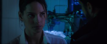 Movie still from “Morbius” (2022), directed by Daniel Espinosa – A woman in a lab coat is looking at the camera; Close Up shot, Over the shoulder angle