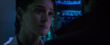 Movie still from “Morbius” (2022), directed by Daniel Espinosa – A woman's face in a dark room; Close Up shot, Over the shoulder angle