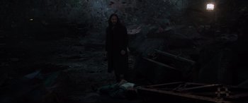 Movie still from “Morbius” (2022), directed by Daniel Espinosa – A man standing next to a dead body in the dark; Wide shot, High angle
