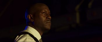 Movie still from “Morbius” (2022), directed by Daniel Espinosa – A person wearing a suit and tie; Close Up shot, Low angle