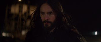 Movie still from “Morbius” (2022), directed by Daniel Espinosa – A man with long black hair and a beard; Close Up shot, Over the shoulder angle