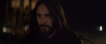 Movie still from “Morbius” (2022), directed by Daniel Espinosa – A person with long hair and a beard; Close Up shot, Over the shoulder angle