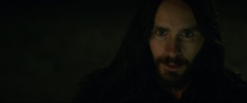 Movie still from “Morbius” (2022), directed by Daniel Espinosa – A man with long black hair and blue eyes; Close Up shot, Over the shoulder angle