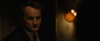 Movie still from “Mudbound” (2017), directed by Dee Rees – A person wearing a suit and tie; Close Up shot, Over the shoulder angle