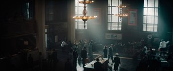 Movie still from “Mudbound” (2017), directed by Dee Rees – A group of people standing in a large room; Extreme Wide shot, High angle