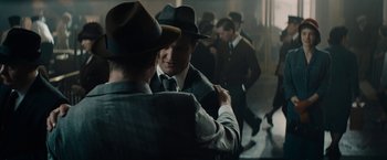Movie still from “Mudbound” (2017), directed by Dee Rees – Two men in suits and hats are looking at each other; Medium shot, Over the shoulder angle