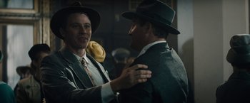 Movie still from “Mudbound” (2017), directed by Dee Rees – A man in a suit and a man in a hat; Medium shot, Over the shoulder angle