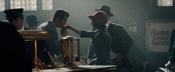 Movie still from “Mudbound” (2017), directed by Dee Rees – A man and a woman in a room with another man; Medium shot, Over the shoulder angle