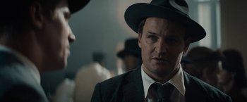 Movie still from “Mudbound” (2017), directed by Dee Rees – A man wearing a suit and a hat; Close Up shot, Over the shoulder angle