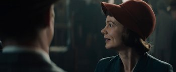 Movie still from “Mudbound” (2017), directed by Dee Rees – A woman wearing a red hat looking up at a man; Close Up shot, Over the shoulder angle