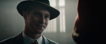 Movie still from “Mudbound” (2017), directed by Dee Rees – A person wearing a suit and a hat; Close Up shot, Over the shoulder angle