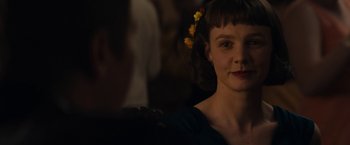 Movie still from “Mudbound” (2017), directed by Dee Rees – A woman with a yellow flower in her hair; Close Up shot, Over the shoulder angle