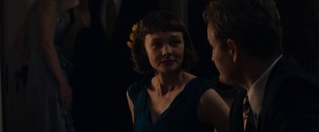 Movie still from “Mudbound” (2017), directed by Dee Rees – A woman with a flower in her hair and a man in a suit; Close Up shot, Over the shoulder angle