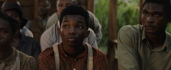 Movie still from “Mudbound” (2017), directed by Dee Rees – A young man sitting in front of an older man; Close Up shot, Over the shoulder angle