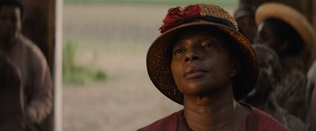 Movie still from “Mudbound” (2017), directed by Dee Rees – A woman wearing a straw hat with a red bow on it; Close Up shot, Low angle