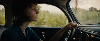 Movie still from “Mudbound” (2017), directed by Dee Rees – A person sitting in the driver's seat of a car; Close Up shot, Over the shoulder angle