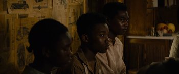 Movie still from “Mudbound” (2017), directed by Dee Rees – A group of young men standing next to each other; Close Up shot, High angle