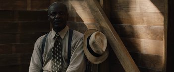 Movie still from “Mudbound” (2017), directed by Dee Rees – An old man wearing a tie and a hat; Close Up shot, Over the shoulder angle