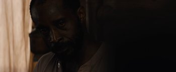 Movie still from “Mudbound” (2017), directed by Dee Rees – A person in a dark room; Close Up shot, Over the shoulder angle
