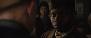 Movie still from “Mudbound” (2017), directed by Dee Rees – A man in a military uniform stares into the camera; Close Up shot, Over the shoulder angle