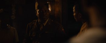 Movie still from “Mudbound” (2017), directed by Dee Rees – A man in a military uniform standing next to another man; Close Up shot, Over the shoulder angle