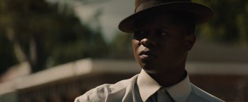 Movie still from “Mudbound” (2017), directed by Dee Rees – A man wearing a hat and a dress shirt; Close Up shot, Low angle