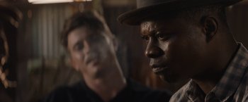Movie still from “Mudbound” (2017), directed by Dee Rees – Two men in hats are looking into the distance; Close Up shot, Over the shoulder angle