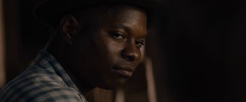 Movie still from “Mudbound” (2017), directed by Dee Rees – A person wearing a hat; Close Up shot, Over the shoulder angle