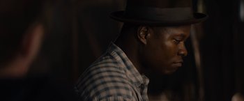 Movie still from “Mudbound” (2017), directed by Dee Rees – A person wearing a hat; Close Up shot, Over the shoulder angle