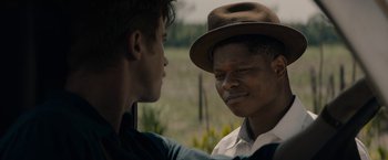 Movie still from “Mudbound” (2017), directed by Dee Rees – Two young men talking to each other in a field; Close Up shot, Over the shoulder angle