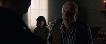 Movie still from “Mudbound” (2017), directed by Dee Rees – An older man and a younger woman in a room; Medium shot, Over the shoulder angle