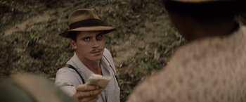 Movie still from “Mudbound” (2017), directed by Dee Rees – A man in a hat holding a piece of paper; Close Up shot, Over the shoulder angle