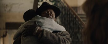 Movie still from “Mudbound” (2017), directed by Dee Rees – A man in a hat is holding a blanket over his face; Close Up shot, Over the shoulder angle