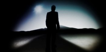 Movie still from “Murder Mystery” (2019), directed by Kyle Newacheck – A man in a suit standing in the middle of the desert; Wide shot, Low angle