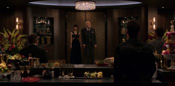 Movie still from “Murder Mystery” (2019), directed by Kyle Newacheck – A man and a woman standing in front of a mirror; Wide shot, Over the shoulder angle